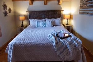 a bedroom with a large bed with a book on it at Sweet Serenity in Gatlinburg