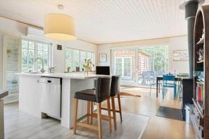 a kitchen with a counter and chairs in a room at 2002-Stege-Solvgranen-7 in Stege +13 photos