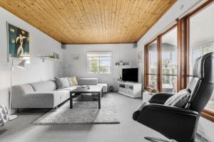 a living room with a couch and a table at R973-Rodvig-Stuven-61 in Rødvig
