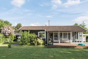 a house with a patio and a yard at R973-Rodvig-Stuven-61 in Rødvig