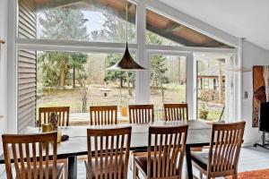 a dining room with a table and chairs and a large window at 2030-Stege-Ulvshalevej-305 in Stege +11 photos