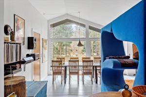 a living room with a blue chair and a table at 2030-Stege-Ulvshalevej-305 in Stege