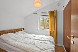 an unmade bed in a bedroom with a window at 2030-Stege-Ulvshalevej-305 in Stege