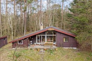 a purple house in the middle of a forest at 2030-Stege-Ulvshalevej-305 in Stege