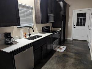 a kitchen with black cabinets and a sink at Special Deal on Booking Unit-558 in Paris