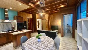 a dining room with a table and a kitchen at T2 Aix-Les-Bains atmosphere chalet in Aix-les-Bains
