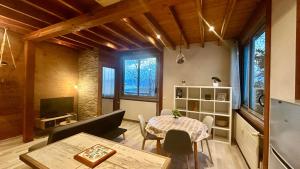 a living room with a table and a dining room at T2 Aix-Les-Bains atmosphere chalet in Aix-les-Bains