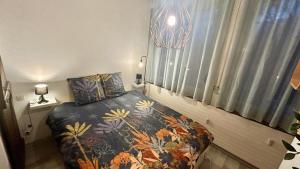 a small bedroom with a bed and a window at T2 Aix-Les-Bains atmosphere chalet in Aix-les-Bains