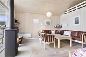 a living room with a couch and a table at 8164-Praesto-Klintestien-16 in Præstø