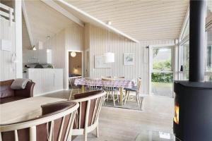 a kitchen and dining room with a table and chairs at 8164-Praesto-Klintestien-16 in Præstø
