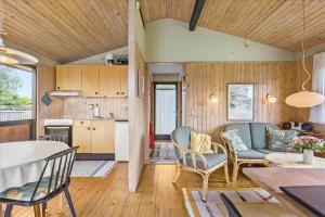 a kitchen and living room with a table and chairs at 1055-Stege-Rylevej-21 in Stege