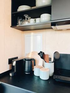 a kitchen counter with utensils on top of it at Tiny Cabin met airco en privé hottub in Rutten +24 photos
