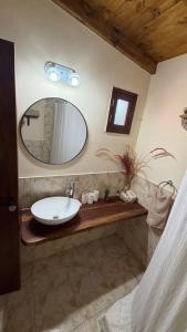 a bathroom with a sink and a mirror at Casa tafi in Tafí del Valle