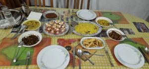 a table with plates and bowls of food on it at Kandy Nest Stay Home in Kandy +9 photos