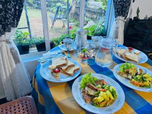 a table with plates of food on top of it at Hidden Treasure in Nuwara Eliya