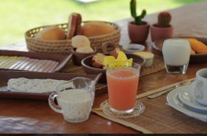 a table with some drinks and baskets of food at Casa levante in Paracuru