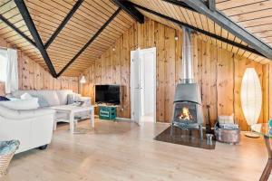 a living room with a couch and a fireplace at 8206-Vordingborg-Havstokken-6 in Vordingborg +20 photos