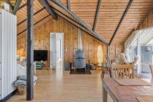 a living room with a wooden ceiling and a fireplace at 8206-Vordingborg-Havstokken-6 in Vordingborg