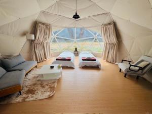 a room with two beds in a tent at KIBOTCHA/キボッチャ in Higashimatsushima