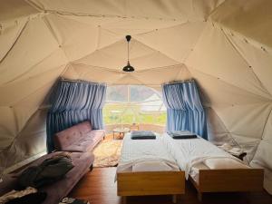 a tent with two beds and a couch in it at KIBOTCHA/キボッチャ in Higashimatsushima +53 photos