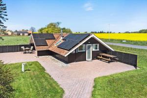 a house with solar panels on its roof in a field at 8206-Vordingborg-Havstokken-6 in Vordingborg