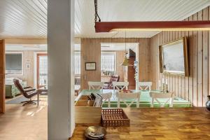 a dining room and living room with a table and chairs at 5015-Askeby-Gormsvej-5 in Askeby