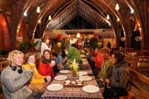 a group of people sitting at a table in a restaurant at Cat Ba Holiday Retreat in Cat Ba