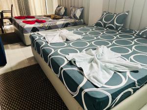 two beds sitting in a room with at Relax On Plus Kelaniya in Kelaniya