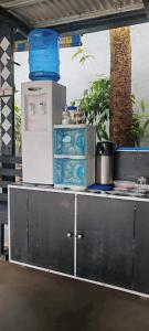 a counter with refrigerators and appliances on top of it at Ezekiel Transient House in Coron