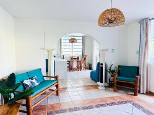 a living room with a couch and a table at Verano Azul Beachfront Apartment in Isabela in Isabela