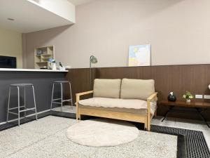 a living room with a couch and a counter at 簃居青衖 in Tainan