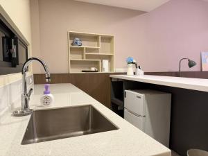 a kitchen with a sink and a counter at 簃居青衖 in Tainan +31 photos