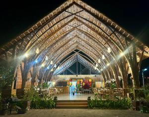 a large greenhouse with tables and chairs in it at night at Cat Ba Holiday Retreat in Cat Ba