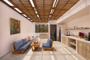 a living room with two chairs and a table at Bohemian Beachfront Apartments in Pabean Buleleng