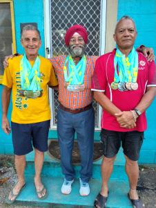 three men standing in front of a house with their medals at Buddle Camping Ground in Nuku‘alofa +7 photos