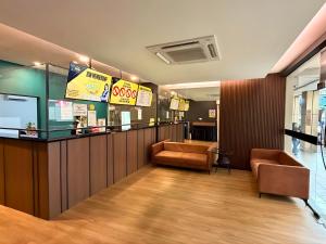 a waiting room with two chairs and a counter at Seeds Hotel Damansara Pelangi in Petaling Jaya