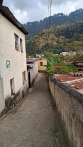 an alley way in a village with a building at Casa Mary in Panajachel