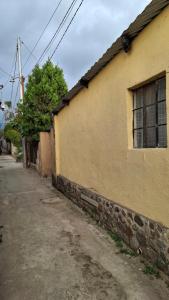 an empty street next to a yellow building at Casa Mary in Panajachel
