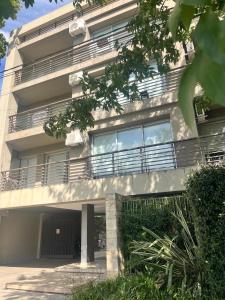 a building with balconies on the side of it at Aires Almafuerte in Saladillo