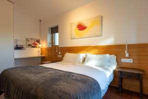 a bedroom with a large bed with a wooden headboard at Villa Can Tomeu Capdet in Sant Pere de Ribes +8 photos