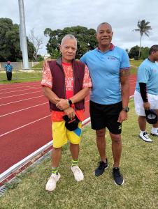 two men are standing next to a race track at Buddle Camping Ground in Nuku‘alofa