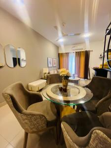 a living room with a table and chairs at sixfive negombo in Negombo