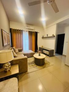 a living room with a couch and a table at sixfive negombo in Negombo