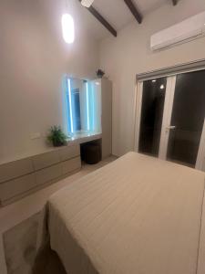 a bedroom with a bed and a large window at sixfive negombo in Negombo