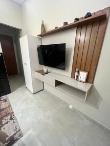 a living room with a flat screen tv on a wall at Exclusive and Central Studio Apartment in Trinidad +2 photos