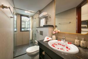 a bathroom with a sink and a toilet and a mirror at Sora Hotel Hanoi in Hanoi +58 photos