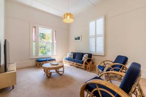 a living room with a couch and a table at Perfect Point Lonsdale Cottage in Point Lonsdale
