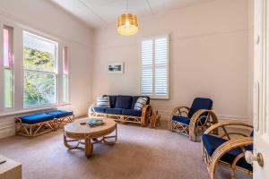 a living room with a couch and chairs and a table at Perfect Point Lonsdale Cottage in Point Lonsdale +20 photos