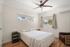 a bedroom with a bed and a ceiling fan at Roderick Street 83, Moffat Beach in Caloundra