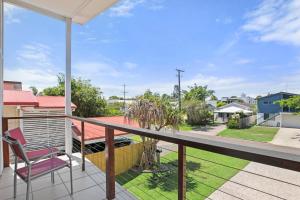 a balcony with a chair and a view of a yard at Roderick Street 83, Moffat Beach in Caloundra